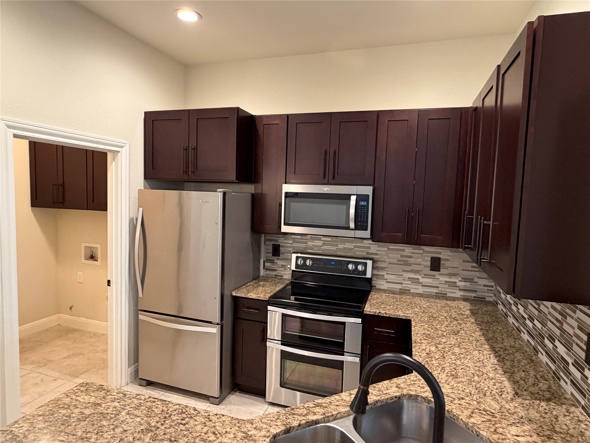 206 Fairway Circle Point Venture, TX 78645 - Photo 7 of 24 a kitchen with a refrigerator sink and stove top oven