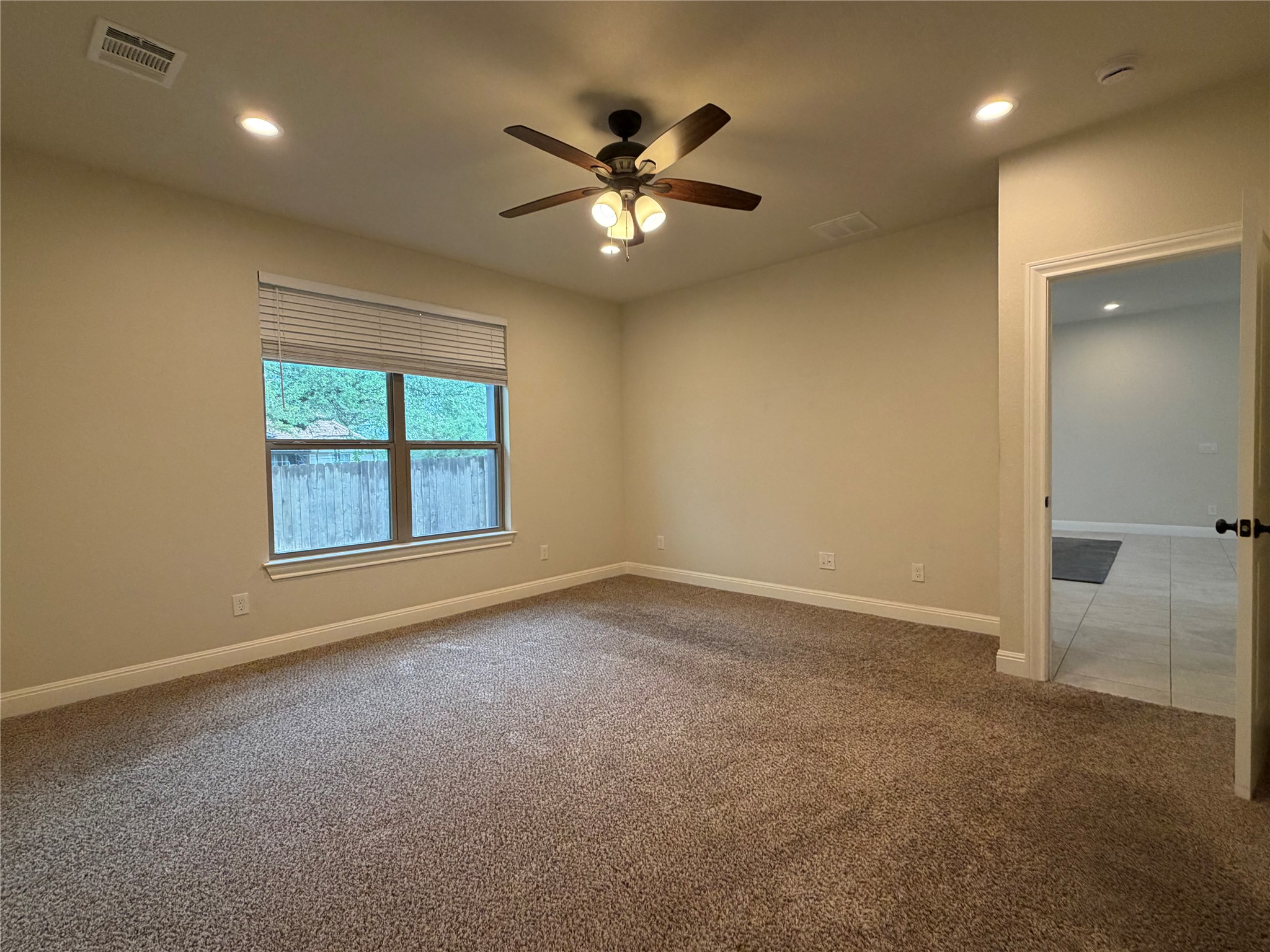 206 Fairway Circle Point Venture, TX 78645 - Photo 10 of 24 an empty room with a ceiling fan and window