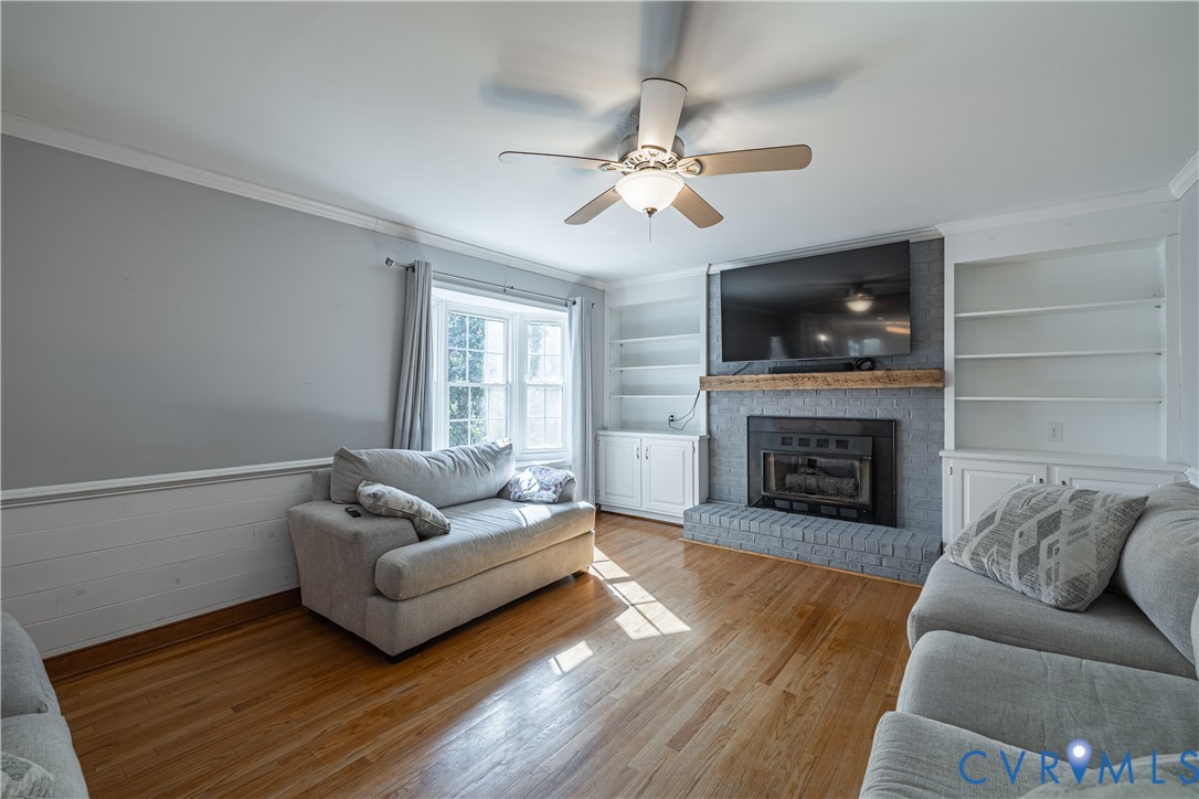 5307 Krag Road Chester, VA 23831 - Photo 18 of 49 a living room with furniture a flat screen tv and a fireplace