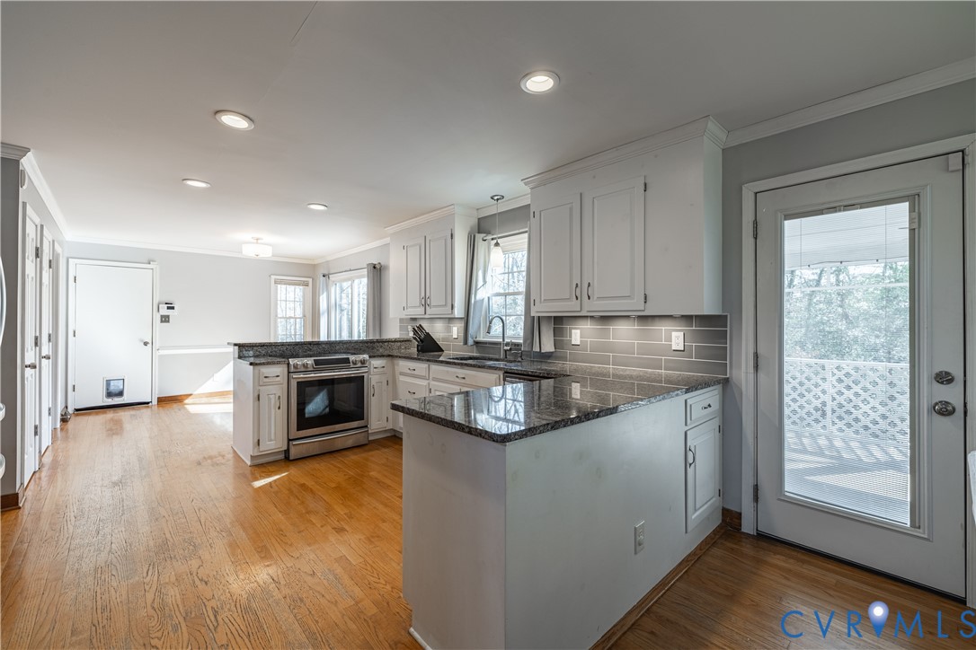 5307 Krag Road Chester, VA 23831 - Photo 21 of 49 a kitchen with stainless steel appliances granite countertop a stove a sink and a refrigerator