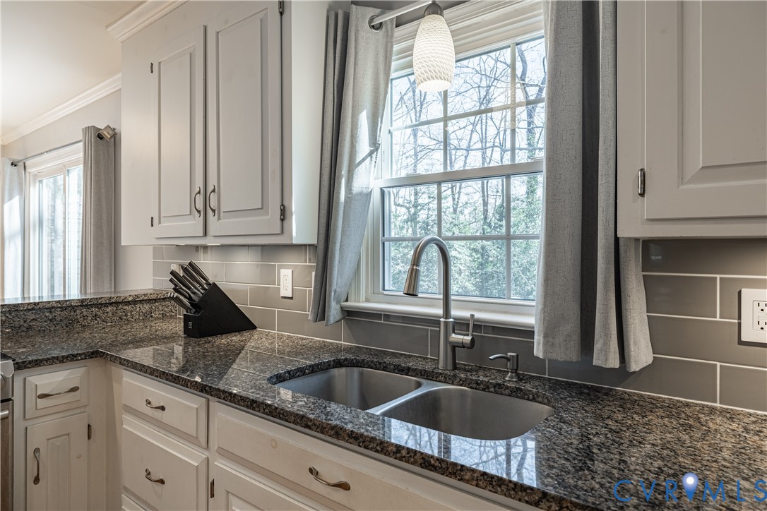 5307 Krag Road Chester, VA 23831 - Photo 23 of 49 a kitchen with granite countertop a sink and a window