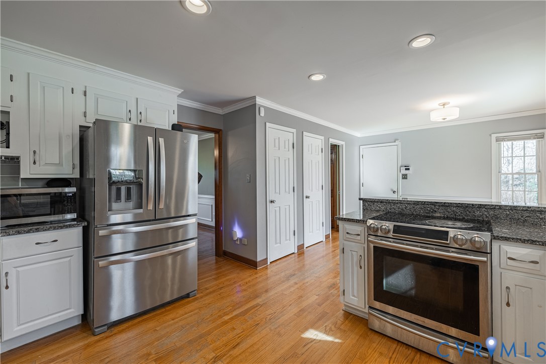 5307 Krag Road Chester, VA 23831 - Photo 24 of 49 a kitchen with wooden floors and stainless steel appliances
