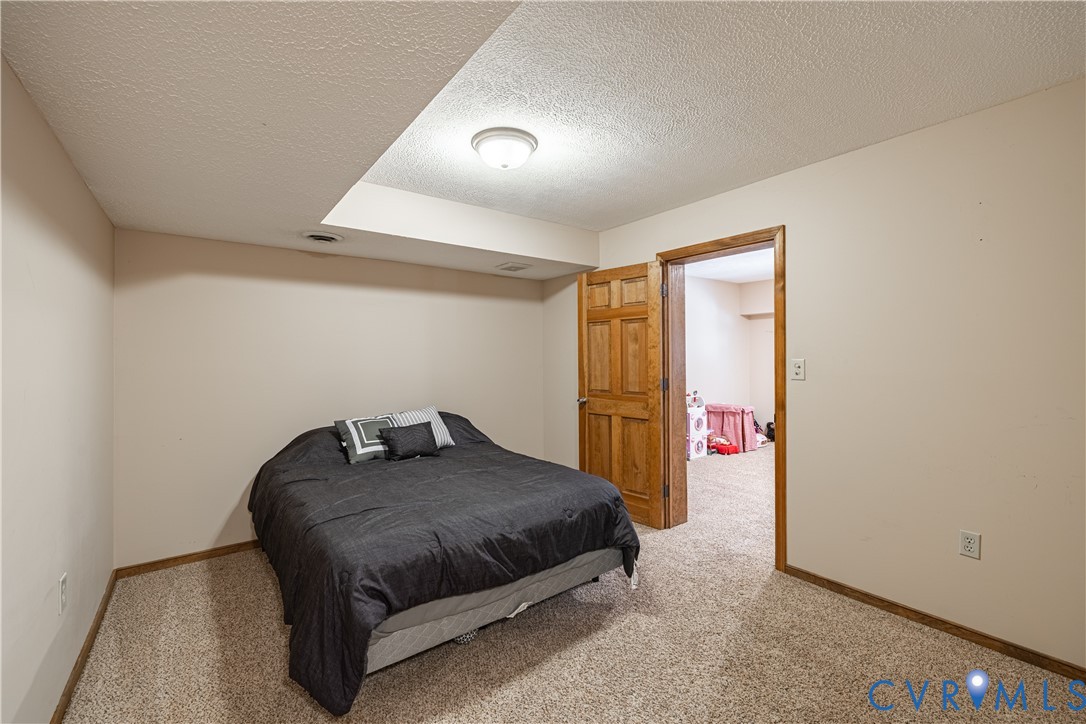 5307 Krag Road Chester, VA 23831 - Photo 29 of 49 a bedroom with a bed and a ceiling fan
