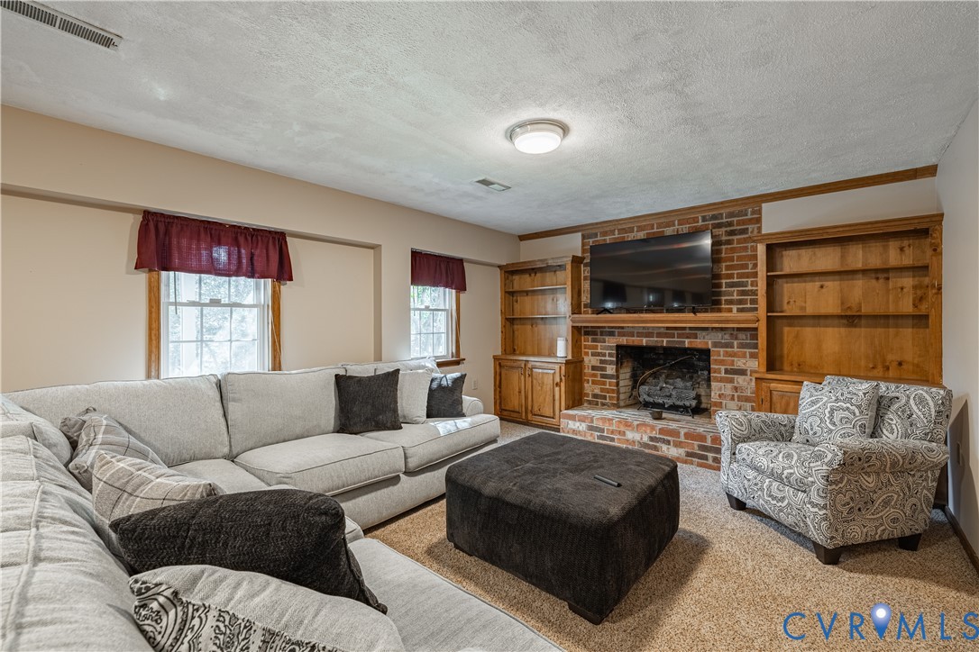 5307 Krag Road Chester, VA 23831 - Photo 33 of 49 a living room with furniture and a fireplace