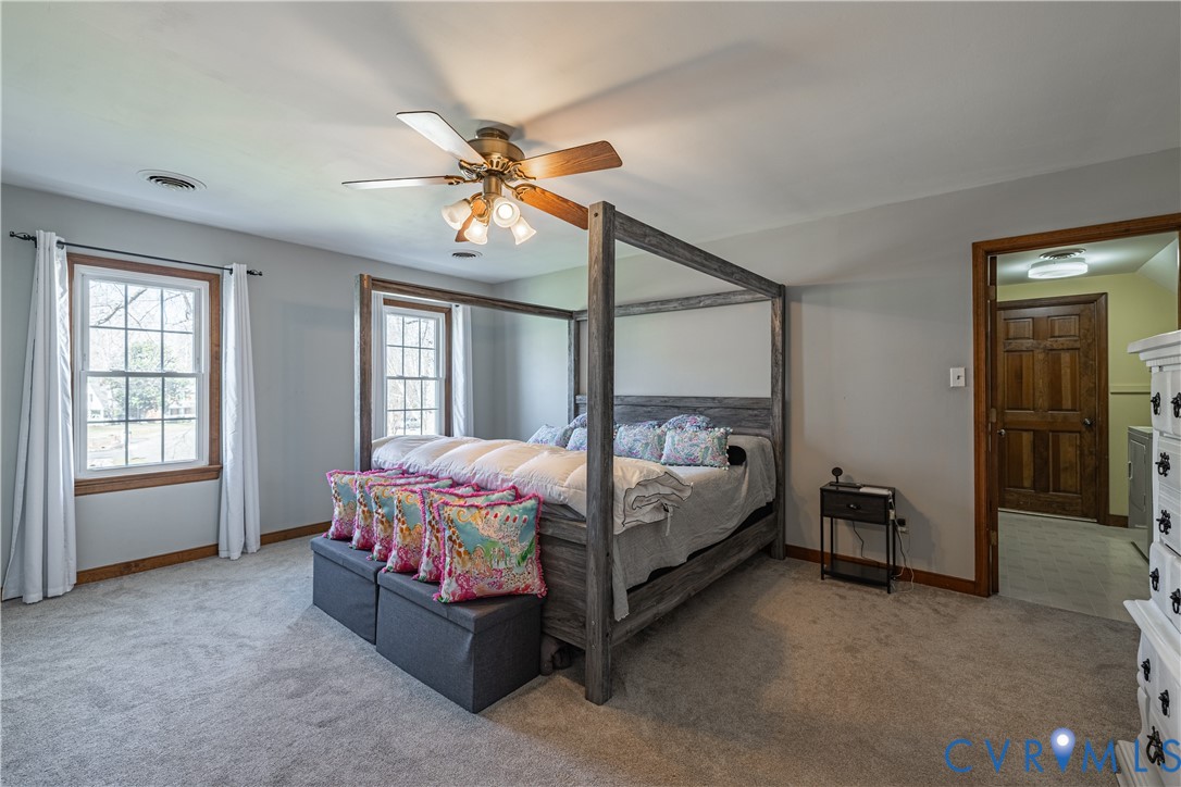 5307 Krag Road Chester, VA 23831 - Photo 38 of 49 a spacious bedroom with a bed and a chandelier