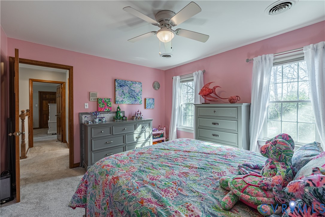 5307 Krag Road Chester, VA 23831 - Photo 44 of 49 a bedroom with a bed and a chandelier