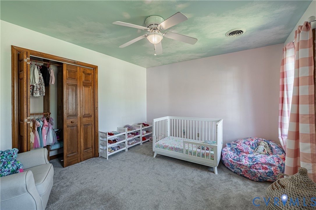 5307 Krag Road Chester, VA 23831 - Photo 45 of 49 a bedroom with furniture and a chandelier fan