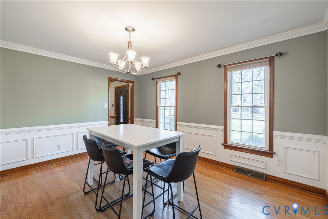 5307 Krag Road Chester, VA 23831 - Photo 48 of 49 a view of a dining room with furniture window and wooden floor