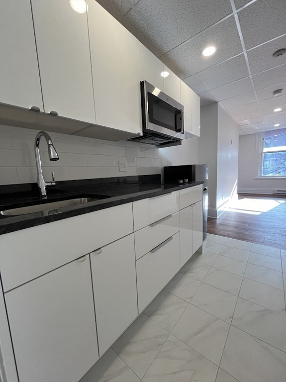 a kitchen with stainless steel appliances granite countertop a sink a stove and a microwave