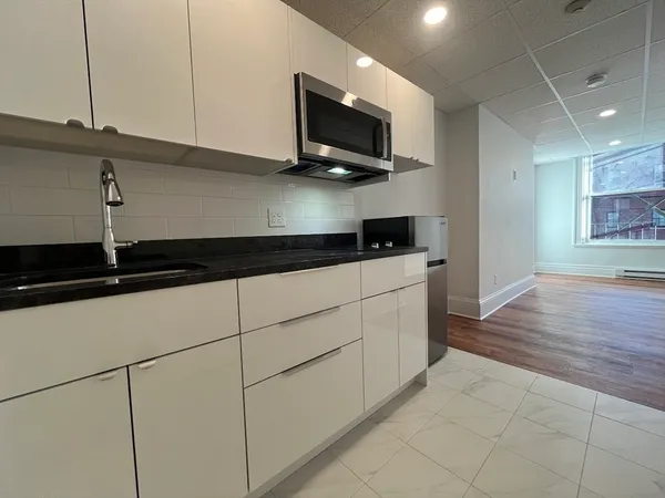 a kitchen with a sink and cabinets