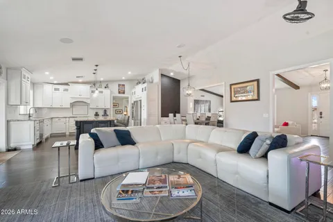 a kitchen with stainless steel appliances granite countertop a refrigerator a oven a sink dishwasher and white cabinets with wooden floor