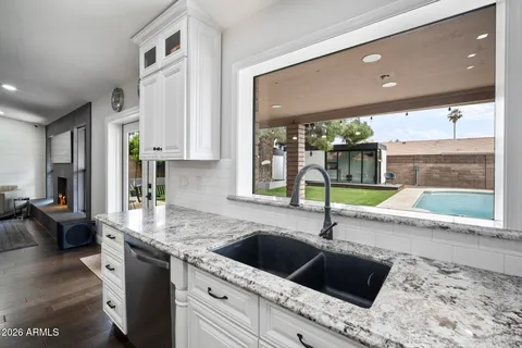 a kitchen with kitchen island a stove a sink and a wooden floors