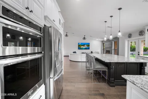a bathroom with a granite countertop sink a mirror and a shower