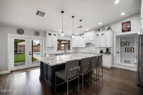 a bathroom with a double vanity sink and a mirror