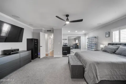 a bedroom with a bed and a tv on the dresser