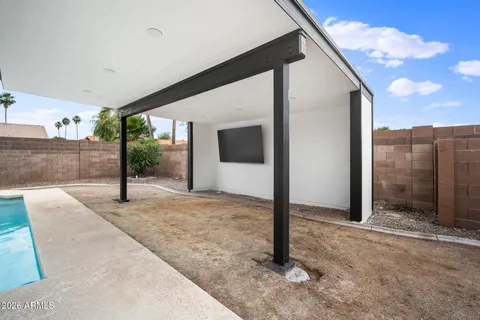 a view of a house with wooden deck and a yard