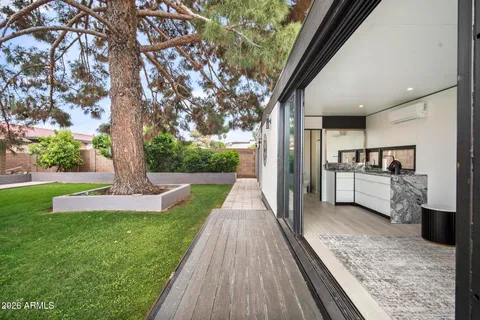 a view of swimming pool with outdoor seating and yard in back