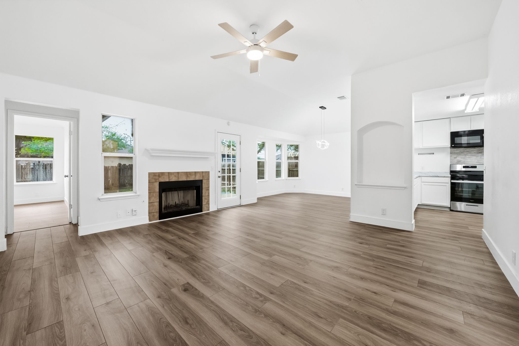 14503 Menifee Street Austin, TX 78725 - Photo 1 of 1 a view of empty room with wooden floor and a fireplace