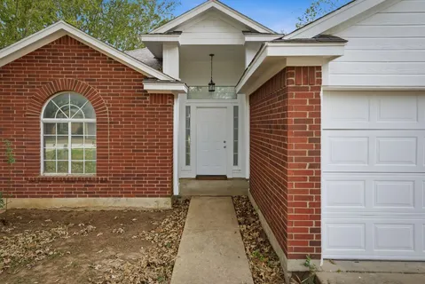 a view of a house with a door and wooden floor