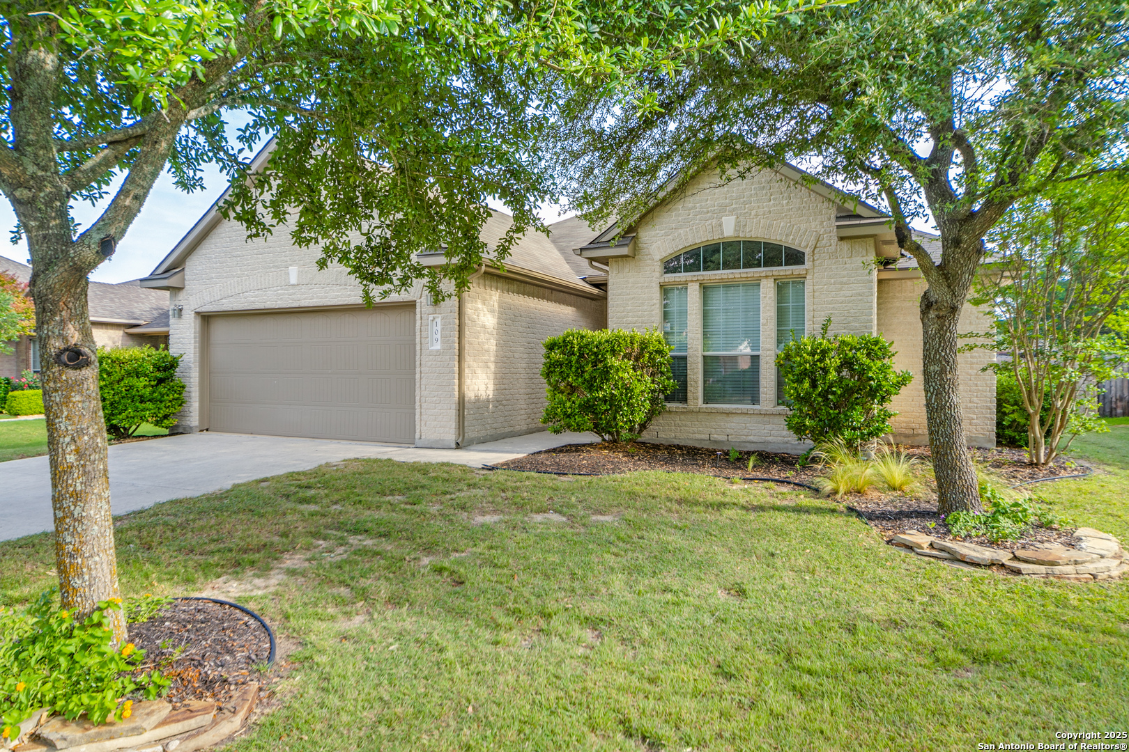 109 Sage Canyon Boerne, TX 78006 - Photo 1 of 25 a front view of a house with a yard and garage
