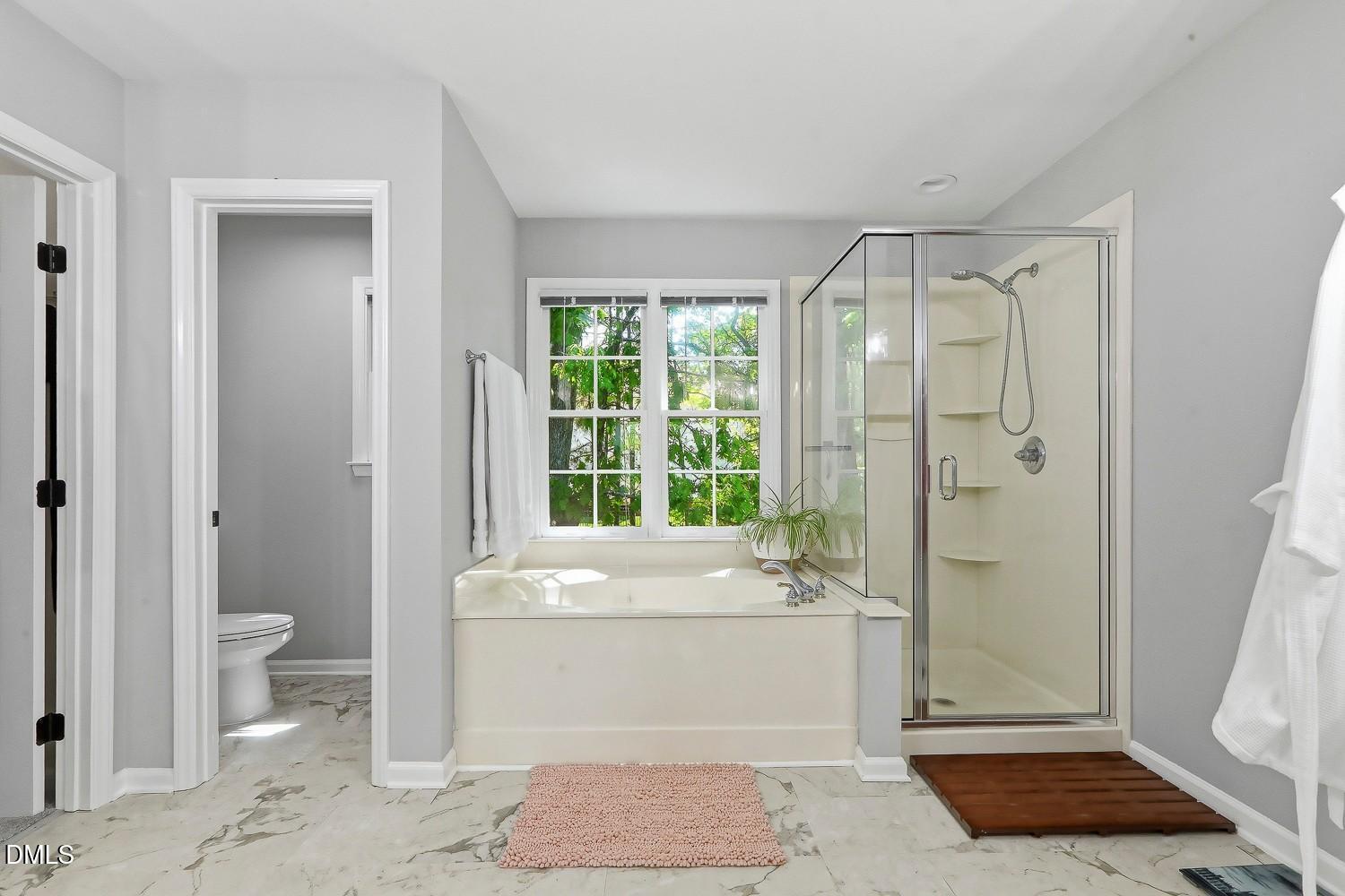 4001 Batiste Road Raleigh, NC 27613 - Photo 31 of 63 a bathroom with a sink a toilet and shower