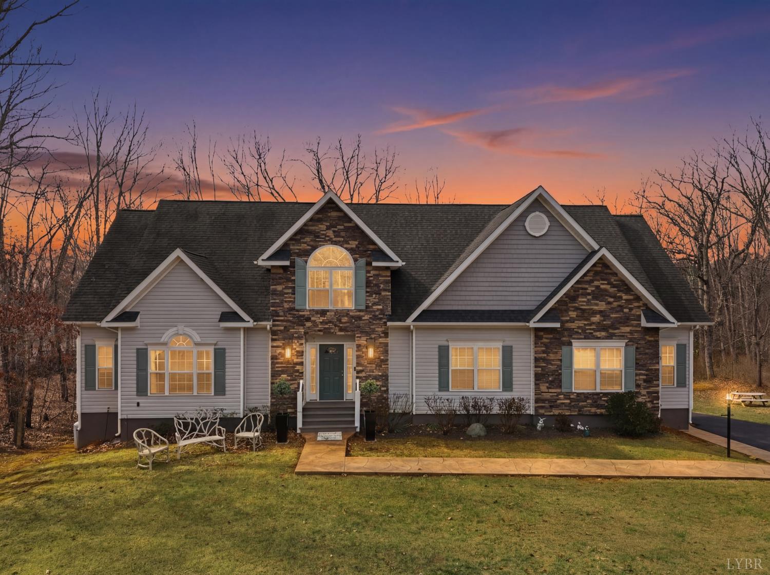 2067 Flint Hill Road Moneta, VA 24121 - Photo 17 of 70 a front view of a house with a yard table and chairs