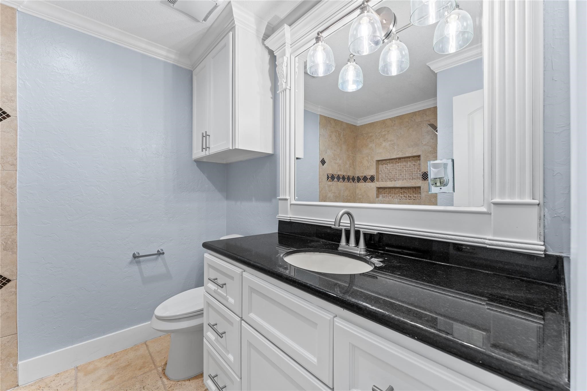 8118 Albacore Drive, Unit 7 Houston, TX 77074 - Photo 11 of 18 a bathroom with a sink a toilet and a mirror