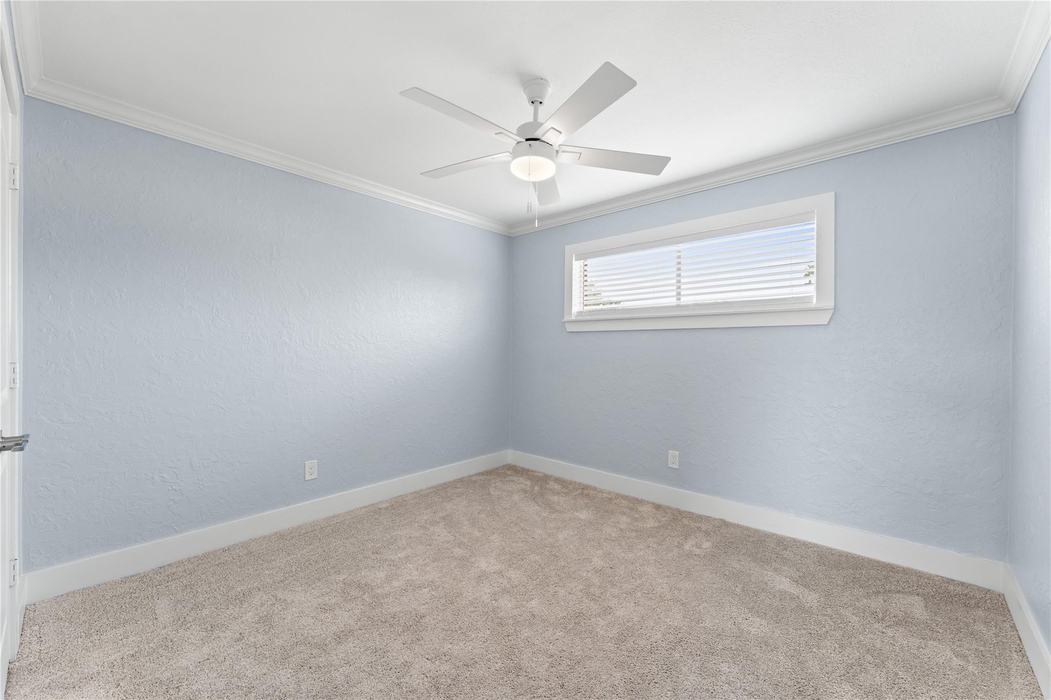 8118 Albacore Drive, Unit 7 Houston, TX 77074 - Photo 9 of 18 an empty room with a window and a fan