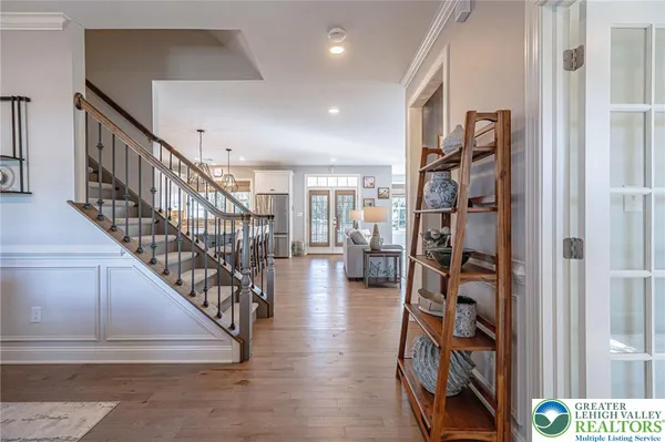 a view of entryway and hall with wooden floor