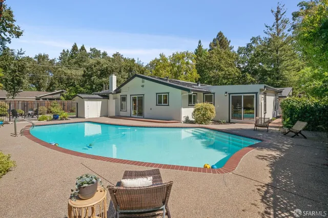 a view of a house with backyard sitting area and garden