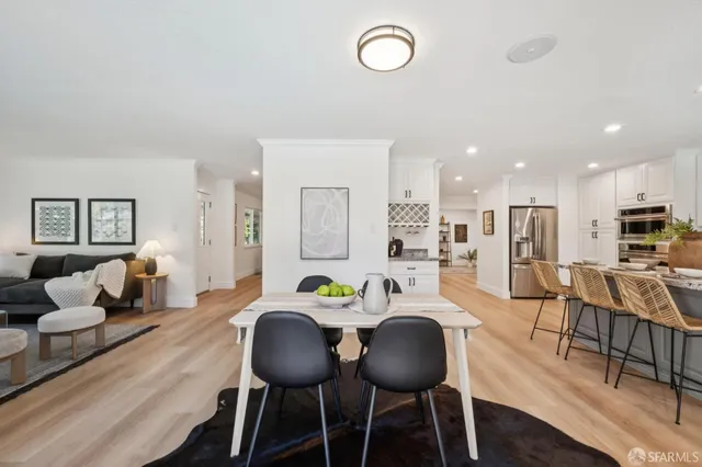 a view of a dining room with furniture and wooden floor