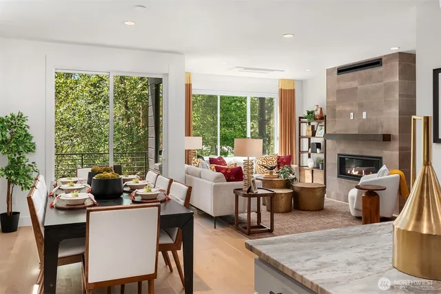 a living room with furniture fireplace and a large window