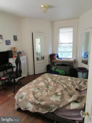 a bedroom with furniture and a window