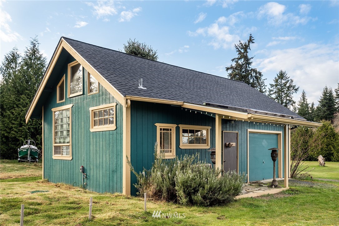 9048 Southwest Soper Road Vashon, WA 98070 - Photo 15 of 27 a front view of a house with a yard