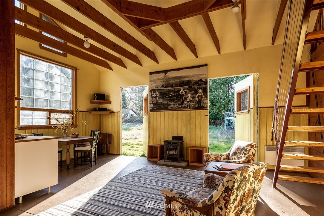 9048 Southwest Soper Road Vashon, WA 98070 - Photo 16 of 27 a view of a living room with furniture and floor to ceiling window