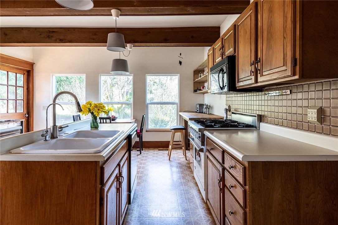 9048 Southwest Soper Road Vashon, WA 98070 - Photo 4 of 27 a kitchen with stainless steel appliances granite countertop a sink stove and cabinets
