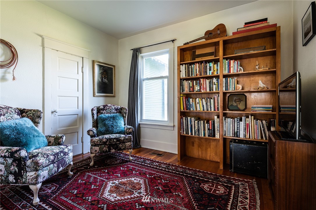 9048 Southwest Soper Road Vashon, WA 98070 - Photo 9 of 27 a living room with furniture a rug and a book shelf