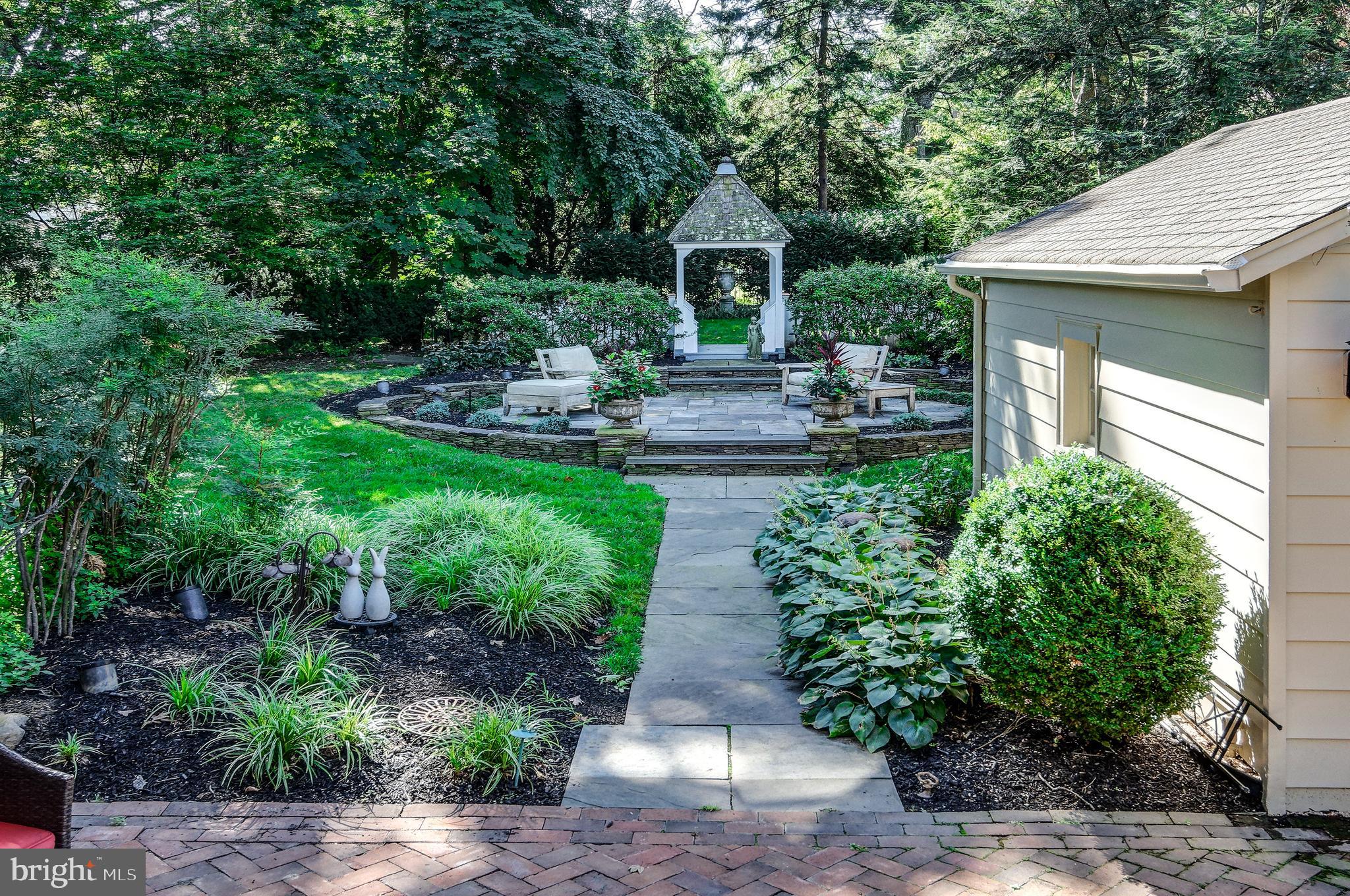 312 Woodland Avenue Haddonfield, NJ 08033 - Photo 12 of 44 a view of a patio with table and chairs potted plants and large tree
