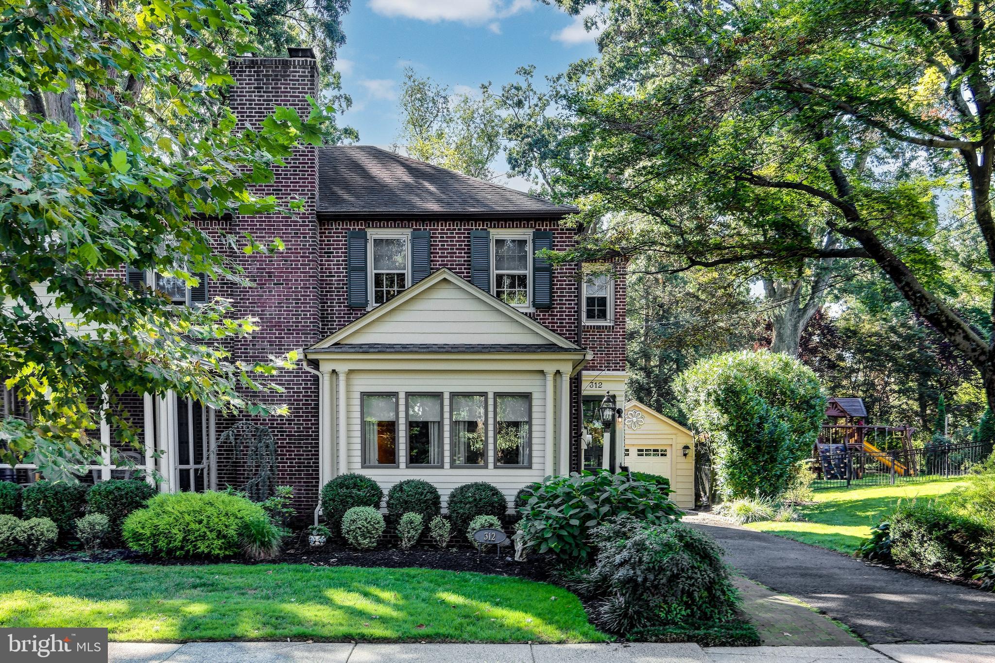312 Woodland Avenue Haddonfield, NJ 08033 - Photo 2 of 44 a front view of a house with a yard