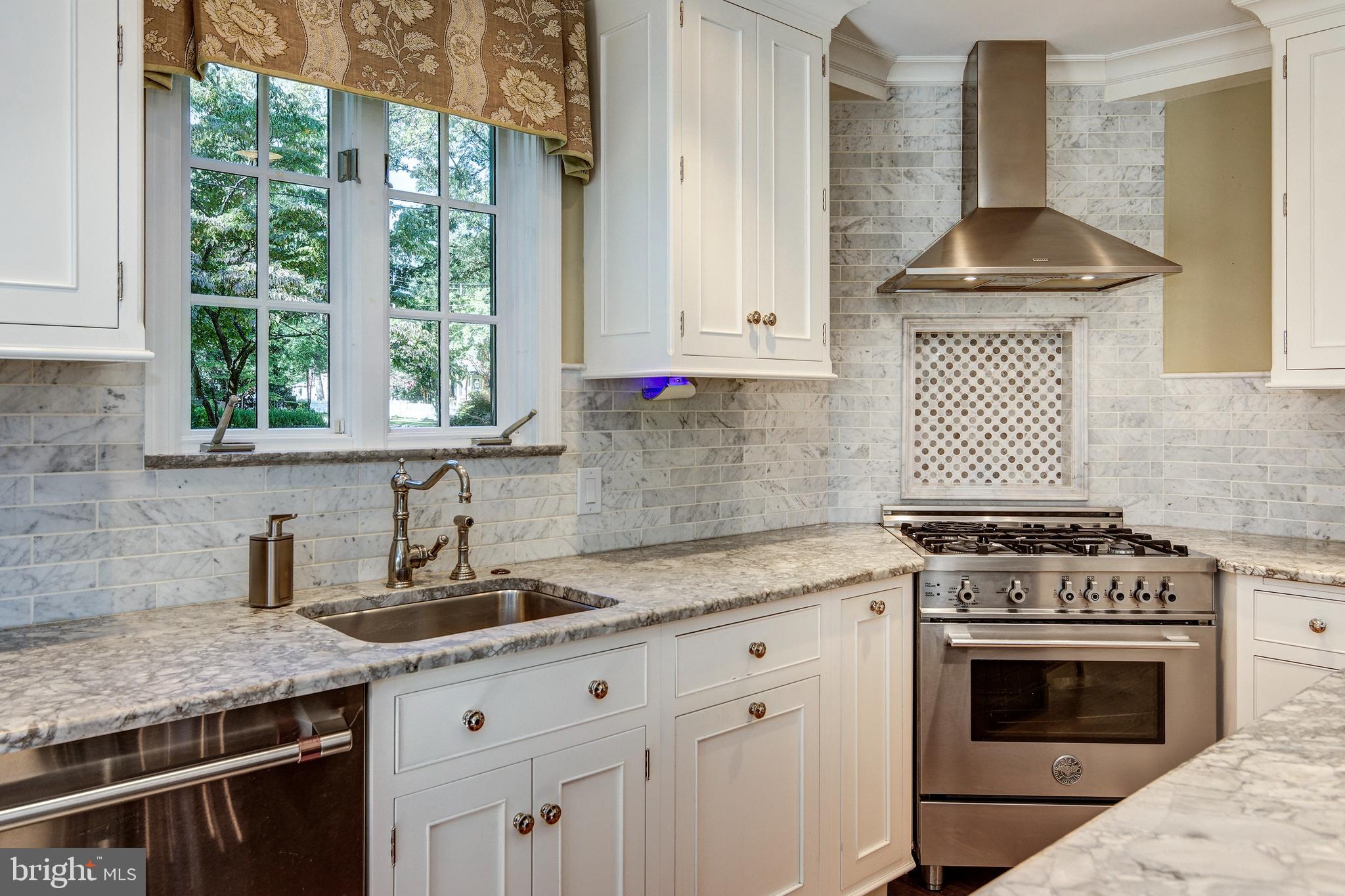 312 Woodland Avenue Haddonfield, NJ 08033 - Photo 29 of 44 a kitchen with granite countertop a stove sink and cabinets