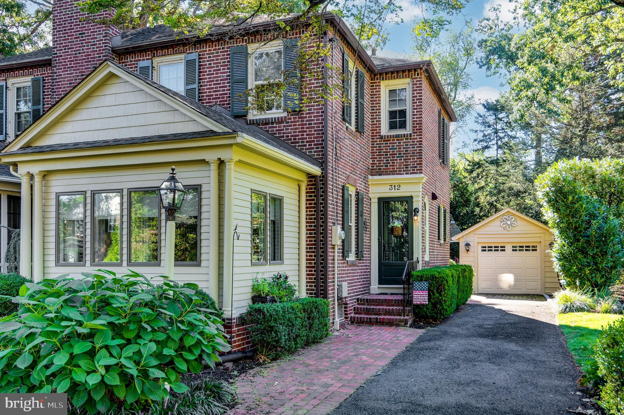 312 Woodland Avenue Haddonfield, NJ 08033 - Photo 3 of 44 a front view of a house with garden