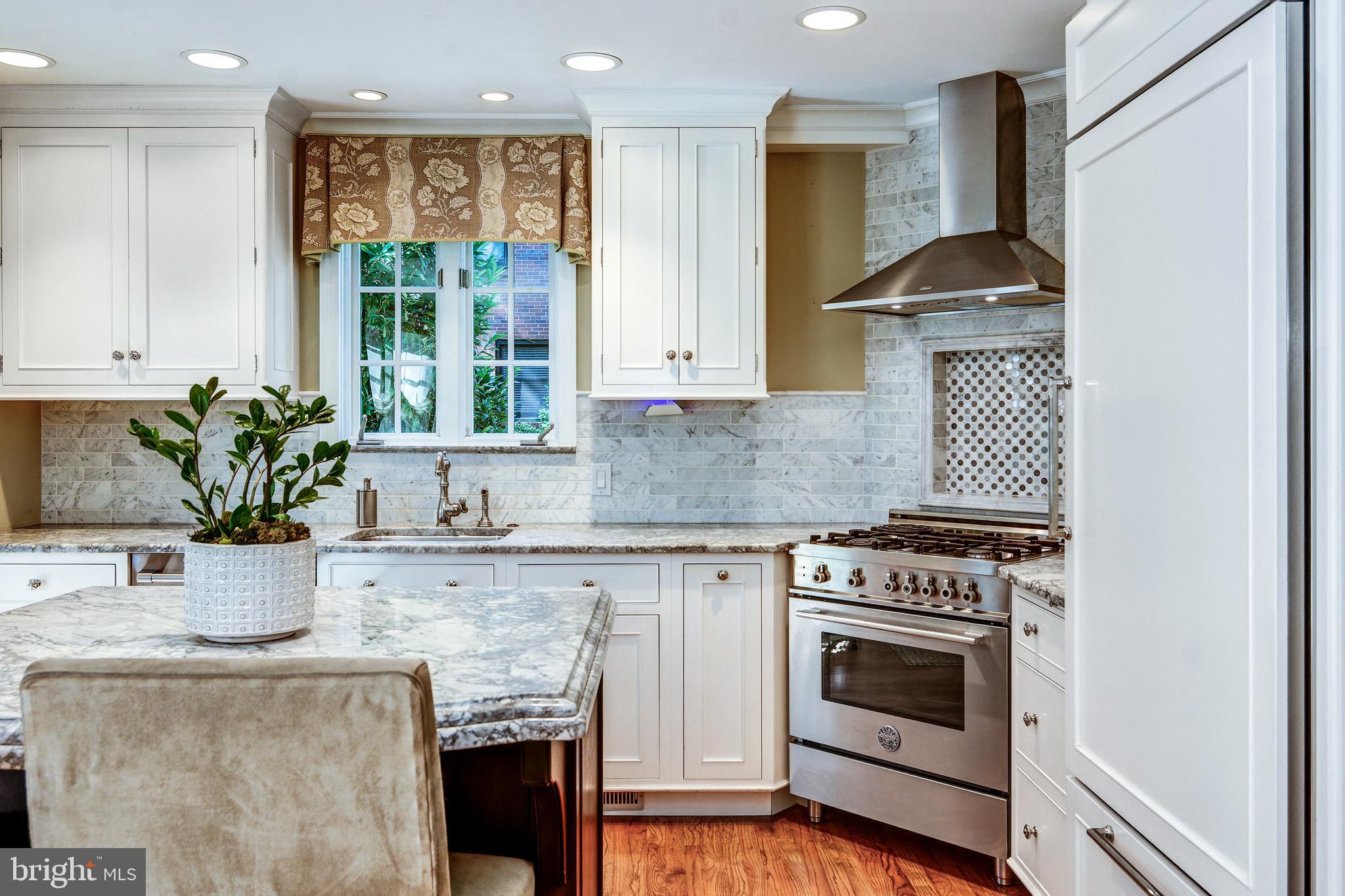 312 Woodland Avenue Haddonfield, NJ 08033 - Photo 31 of 44 a kitchen with granite countertop a stove a sink and a potted plant