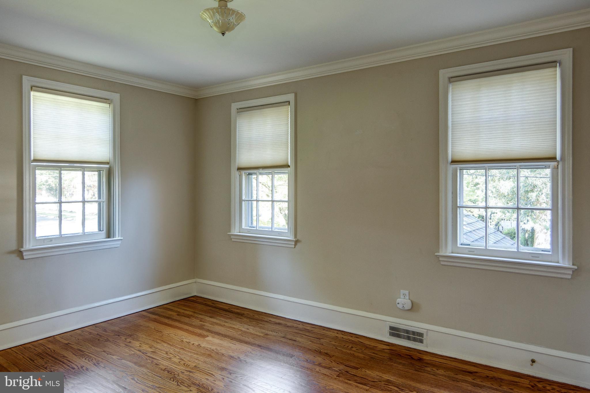 312 Woodland Avenue Haddonfield, NJ 08033 - Photo 33 of 44 a view of an empty room with wooden floor and a window