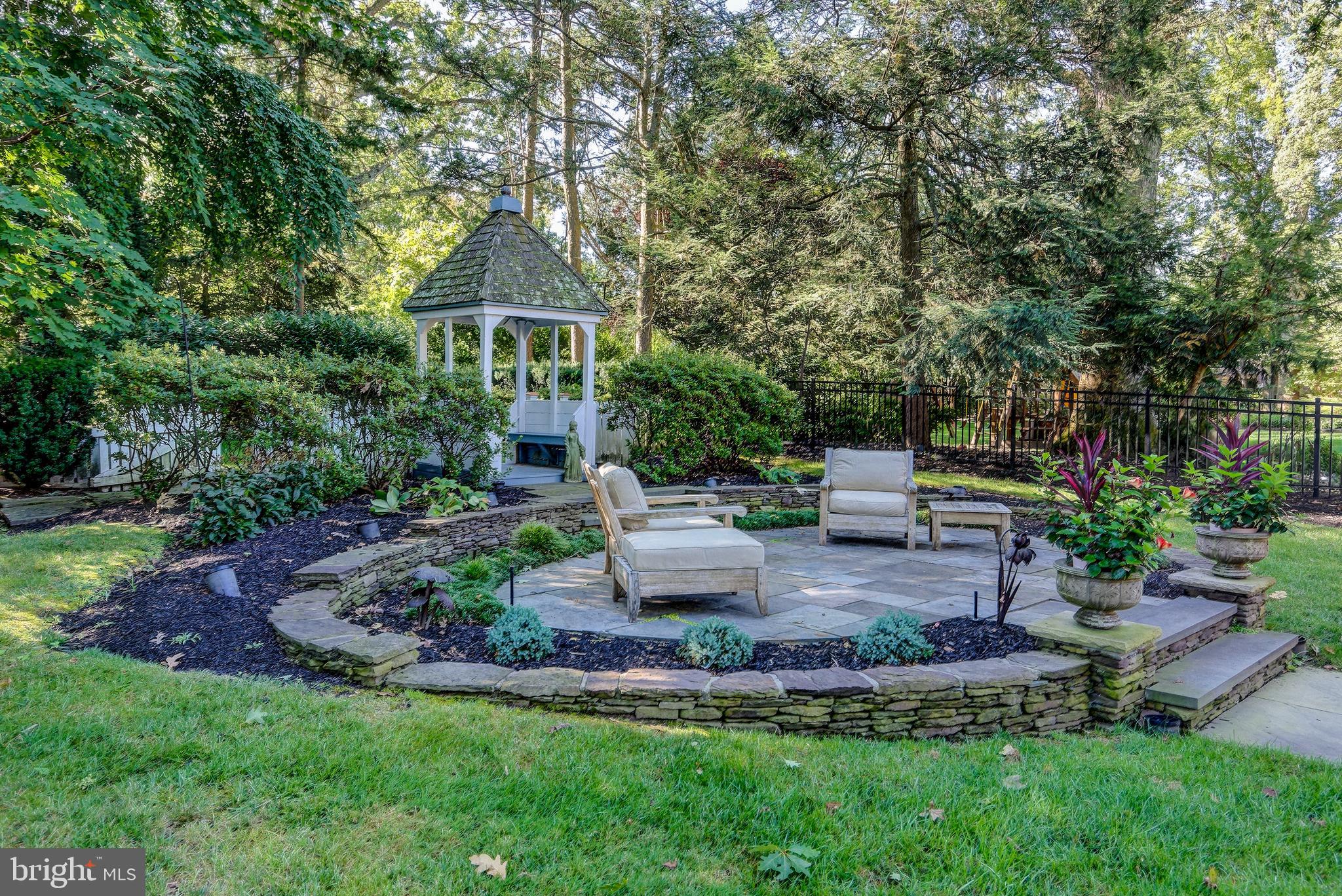 312 Woodland Avenue Haddonfield, NJ 08033 - Photo 6 of 44 a front view of a house with a garden