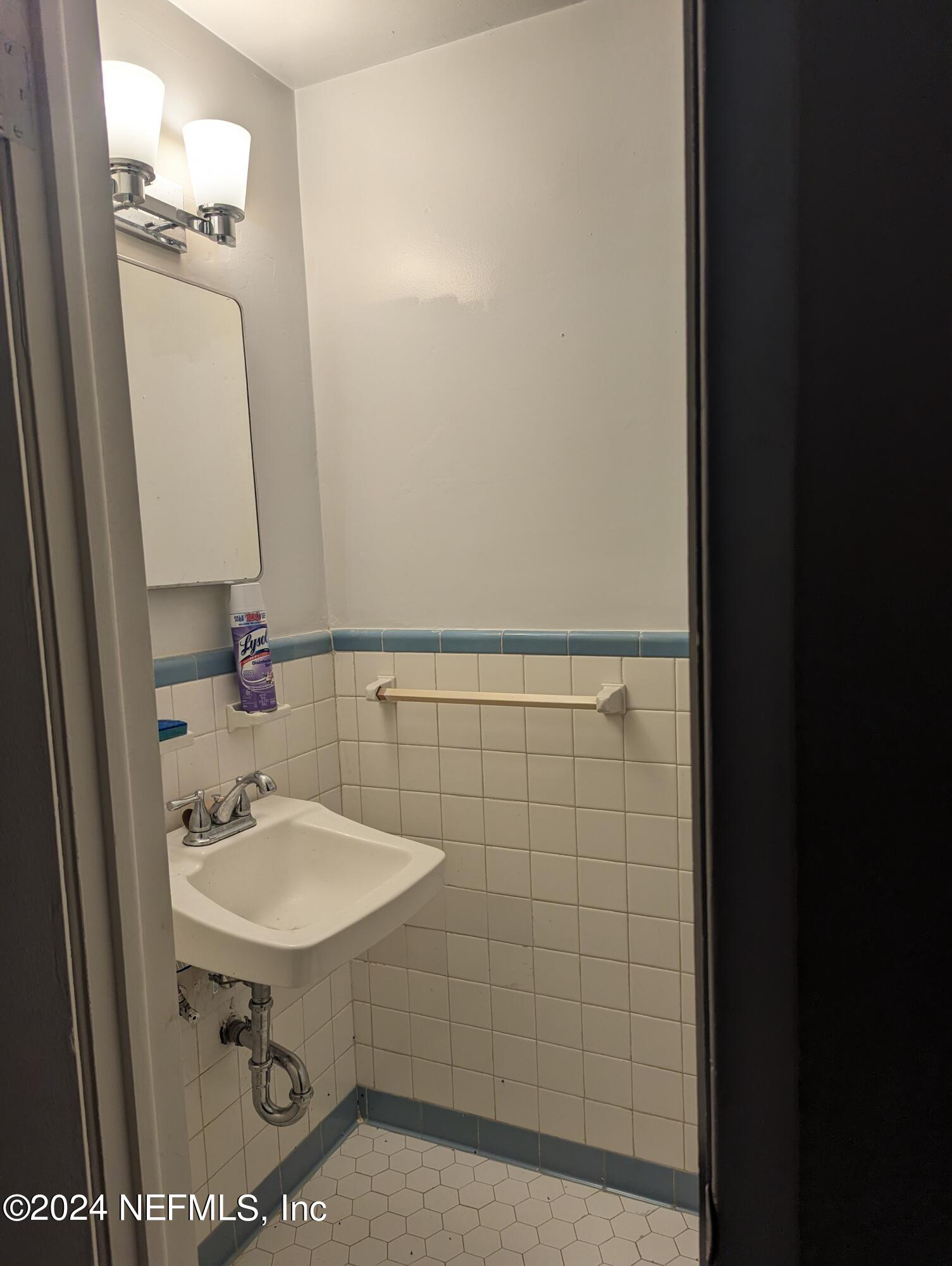 5120 Oakside Drive Jacksonville, FL 32244 - Photo 11 of 24 a bathroom with a sink a mirror and shower