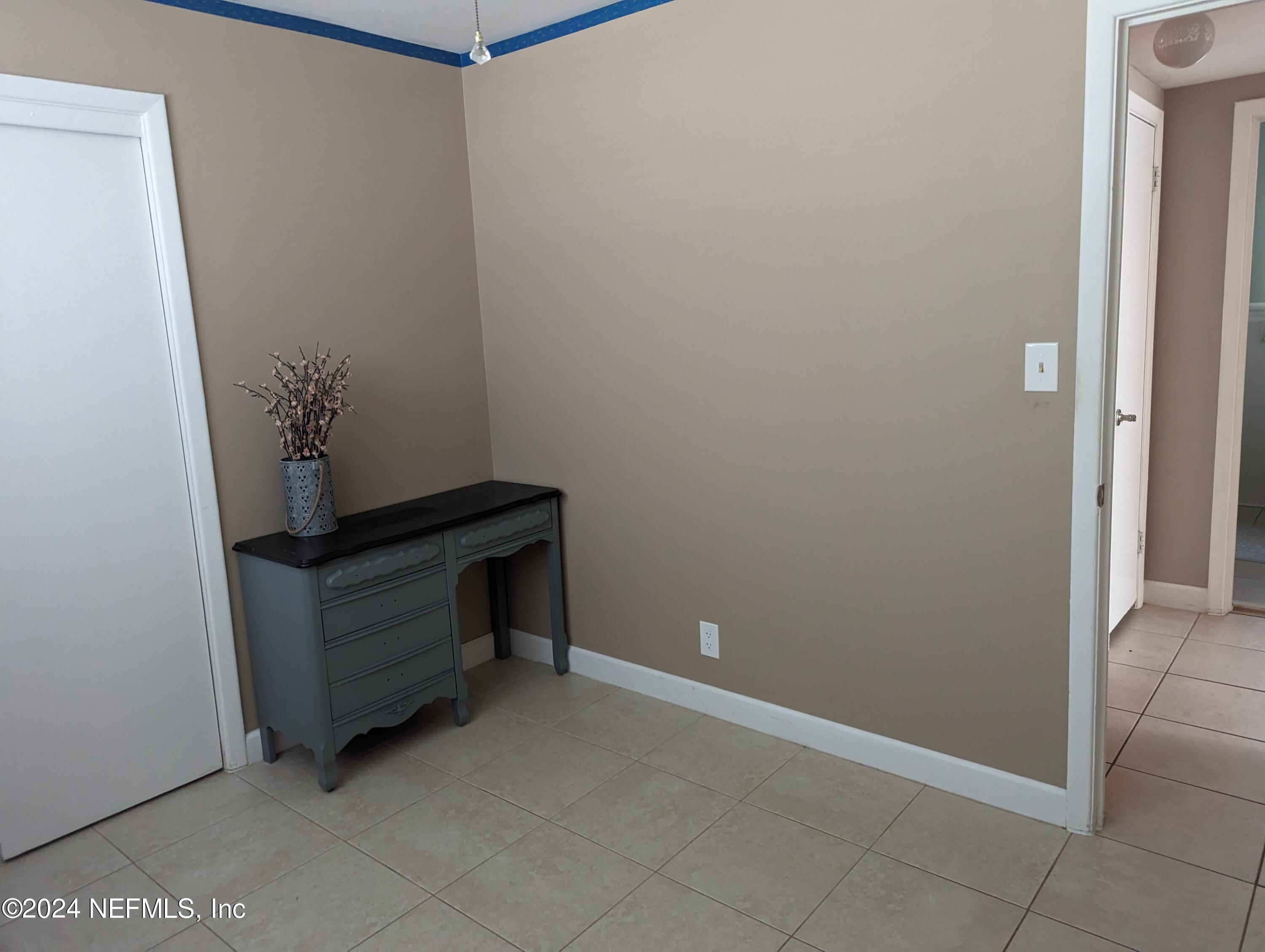 5120 Oakside Drive Jacksonville, FL 32244 - Photo 18 of 24 a room with a bench