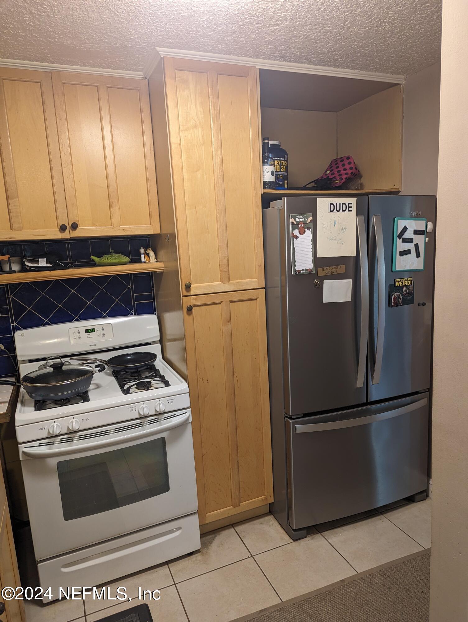 5120 Oakside Drive Jacksonville, FL 32244 - Photo 7 of 24 a kitchen with wooden cabinets and stainless steel appliances