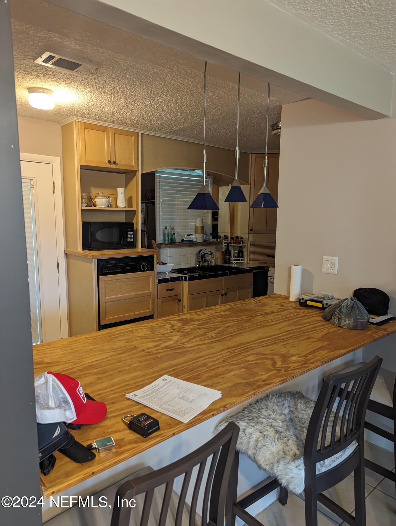 5120 Oakside Drive Jacksonville, FL 32244 - Photo 9 of 24 a view of kitchen dining room and wooden floor