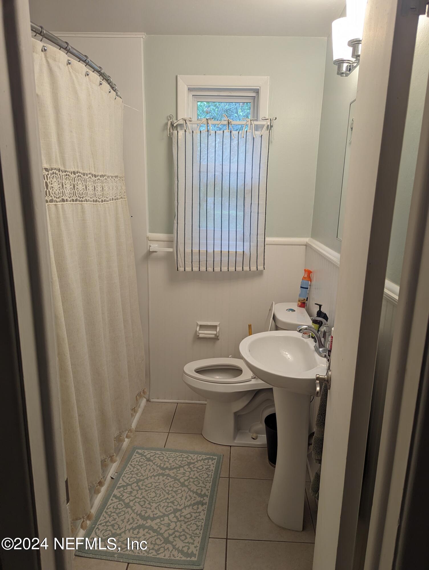 5120 Oakside Drive Jacksonville, FL 32244 - Photo 10 of 24 a bathroom with a sink a toilet and a mirror
