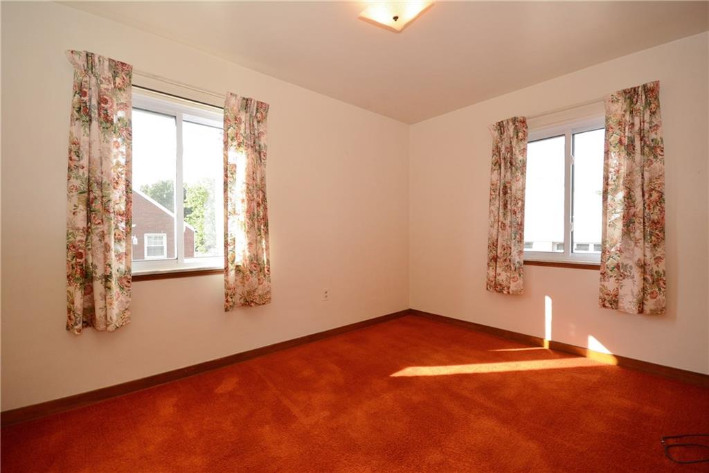 1034 Silver Lane McKees Rocks, PA 15136 - Photo 14 of 25 Bedroom two is also found on the main level. It has windows on two walls and hardwood floors beneath the wall to wall carpeting. If not needed as such, it would make a fabulous den or home office.